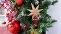 New Year`s composition of fir branches, Christmas tree toys in the form of stars, balls and golden twigs on makro street