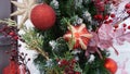 New Year`s composition of fir branches, Christmas tree toys in the form of stars, balls and golden twigs on makro street