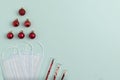 New Year`s composition of three masks, New Year`s red balls lying in the shape of a Christmas tree and test tubes with sparkles