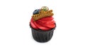 New year`s cupcake with red buttercream, decorated with blueberries, gingerbread snowflake and a sprig of firtree.