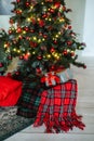 New year`s decor. Red pillows, green plaid, Christmas gifts