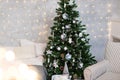 New Year`s decor in the room with a Christmas tree, a fireplace and gifts