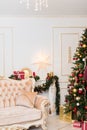 New Year`s decor in the room with a Christmas tree, a fireplace and gifts
