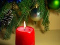 New Year\'s decorations. Pine cone, candle, balls and fir branches on a beige background