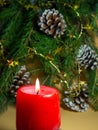 New Year\'s decorations. Pine cone, candle and fir branches on a beige background