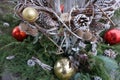 New Year`s decoupage made from balls, cones, painted branches with leaves and green spruce branches