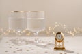 New Year's eve celebration concept, golden clock with twelve o'clock time, midnight, on beige table with gold Royalty Free Stock Photo