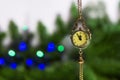 New Year`s Eve, the clock - the medallion shows 23.55. Soon a new time. on the background of a green Christmas tree