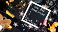 New Year`s Eve resolutions letter board and black and gold party decorations. Royalty Free Stock Photo