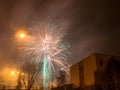 New Year`s fireworks create smoke over houses on the outskirts of the city - Long exposure at night on New Year Royalty Free Stock Photo