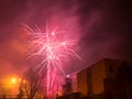 New Year`s fireworks create smoke over houses on the outskirts of the city - Long exposure at night on New Year Royalty Free Stock Photo