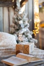 New Year`s gift on the bed. Scandinavian bedroom interior under Christmas. Rustic Textured Wooden Bed Royalty Free Stock Photo