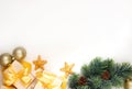 New Year`s gifts with a golden bow, a fir branch on a light background. Flat lay, top view, copy space for text. Christmas festiv