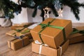 New Year`s gifts under the tree. festive craft boxes under the spruce. surprise and joy for children