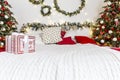 New Year`s home interior. Bed, decorated Christmas trees, gifts, garlands. Decoration for traditional winter holidays Royalty Free Stock Photo
