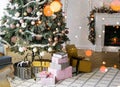 New Year`s ÃÂhristmas-tree by the fireplace with gifts, balls and lights. Christmas and New Years