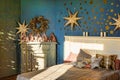 New Year`s interior. Bedroom with fireplace decorated with Christmas stars. Sweet home, family holiday concept Royalty Free Stock Photo