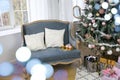 New Year`s interior with ÃÂhristmas-tree decorations, balls and lights. Comfortable blue sofa with pillows in the room. Classics Royalty Free Stock Photo