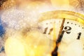 new Year& x27;s at midnight - clock at twelve o& x27;clock with holiday lights and fireworks Royalty Free Stock Photo