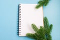 Notebook and Christmas tree branches. Christmas planning concept. Place for text. Christmas and New Year`s composition. Royalty Free Stock Photo