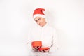 New Year`s photo. A man in a santa hat on a white background holds a box in his hands, the guy looks into an empty box, there is Royalty Free Stock Photo