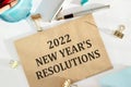 2022 New Year`s Resolutions list on white wooden table in office workplace Royalty Free Stock Photo