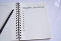 New Year`s Resolutions text on a notepad with reflection of window glass