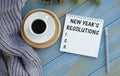 New year`s Resolutions Text Written on Notepad With Laptop and Cup of Coffee on Top Royalty Free Stock Photo