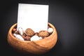 New Year`s resolutions, Wooden bowl with nuts, walnuts and hazelnuts, copy space on black background Royalty Free Stock Photo