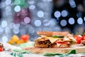 New Year`s sandwich with chicken, tomatoes, cheese, sauce and lettuce on a wooden board Royalty Free Stock Photo