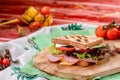 New Year`s sandwich with sausage, tomatoes, cheese, sauce and lettuce on a wooden board Royalty Free Stock Photo