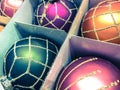 New Year`s shiny toys, decor purple, blue, green Christmas balls in transparent plastic boxes are sold in the Christmas market. Royalty Free Stock Photo