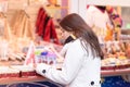 New Year`s shopping. Young girl chooses gifts, souvenirs at the Christmas market Royalty Free Stock Photo