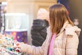 New Year`s shopping. Young girl chooses gifts, souvenirs at the Christmas market Royalty Free Stock Photo