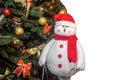 New Year\'s soft toy white snowman near the Christmas tree on a isolated background