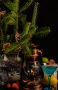 New year`s still life. On a dark background, branches of a fir tree in a large vase next to an old kerosene lamp Royalty Free Stock Photo
