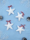 Christmas tree decorations in the shape of a star with white snowflakes on a blue background and pine Royalty Free Stock Photo