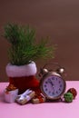 New Year`s still life with gifts, Christmas decorations and an alarm clock on a colored background. Close up with copy space Royalty Free Stock Photo