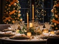 New Year\'s table setting, wine glasses, burning candles, plates, cutlery