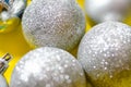 New Year`s toys balls on a Christmas tree on a white and yellow background. Multi-colored balls, decoration. Celebration Royalty Free Stock Photo