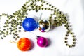 New Year`s toys balls on a Christmas tree on a white and yellow background. Multi-colored balls, decoration. Celebration Royalty Free Stock Photo