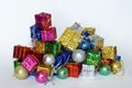 New Year`s toys and multicolored shiny boxes with gifts lie on a white background. Big and small. Holiday sale and foil packaging