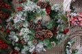 New Year`s wreath of cones of cones and red berries under artificial snow Royalty Free Stock Photo