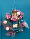 New Year`s wreath with a figure of a nutcrack hanging on a wooden door