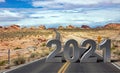 2021 New year sign on long winding road and cloudy blue sky background, USA. 3d illustration Royalty Free Stock Photo