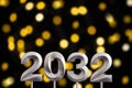 New year 2032 - Silver number on black background with defocused lights