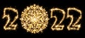 New Year 2022 with snowflake made by sparkler . Number 2022 and sign written sparkling sparklers . Isolated on a black background Royalty Free Stock Photo