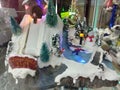 New year souvenir composition with artificial snow, fir trees and skiers