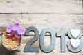 New Year 2018, spa set on wooden table, coconut and bath salt, flower of orchids and white stones in the shape of a heart. Royalty Free Stock Photo