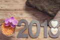 New Year 2018, spa set on wooden table, towel, coconut and bath salt, flower of orchids and white stones in the shape of a heart Royalty Free Stock Photo